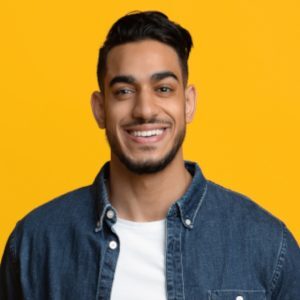 Smiling Middle Eastern Man In Casual With Laptop Y9EY47V
