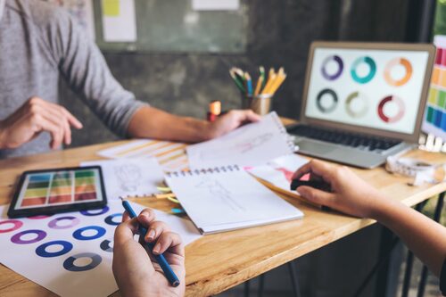 Cropped Hands Woman Holding Pencil By Colleague Creative Office